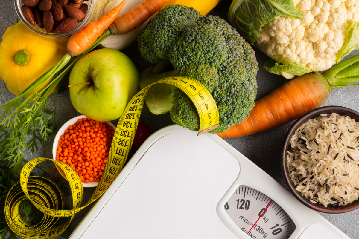 A smiling person standing on a scale, surrounded by visuals of balanced high-calorie and low-calorie meals, fitness gear, and progress charts, representing the benefits of metabolic confusion.