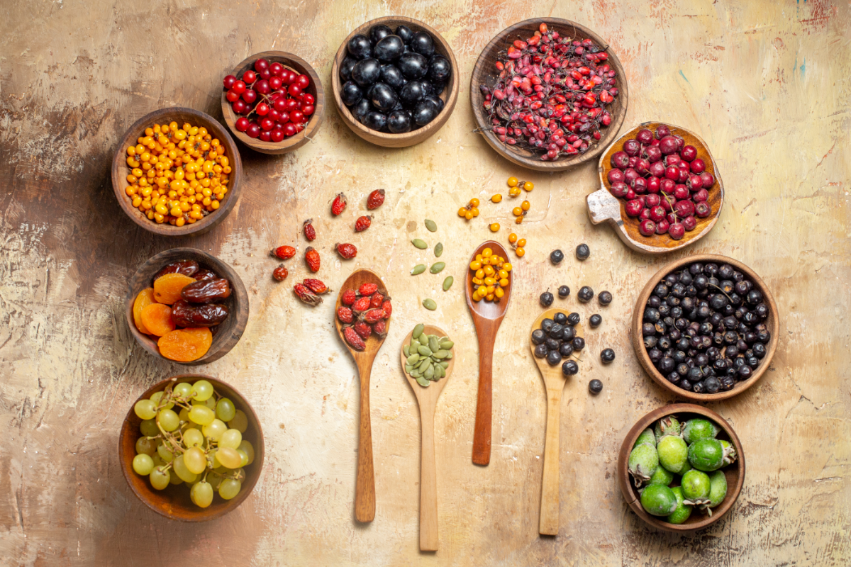 A colorful assortment of superfoods such as berries, leafy greens, nuts, seeds, and avocado, arranged to highlight their rich nutrient profile.