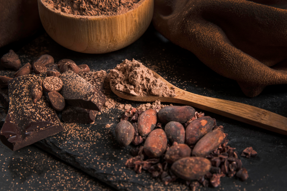 A bowl of cocoa powder highlighting its antioxidant benefits, metabolism-boosting properties, and mood-enhancing effects.